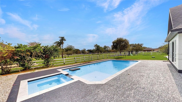 view of swimming pool featuring a patio area, a yard, and an in ground hot tub