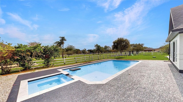 view of pool featuring a patio, a pool with connected hot tub, a lawn, and a fenced backyard