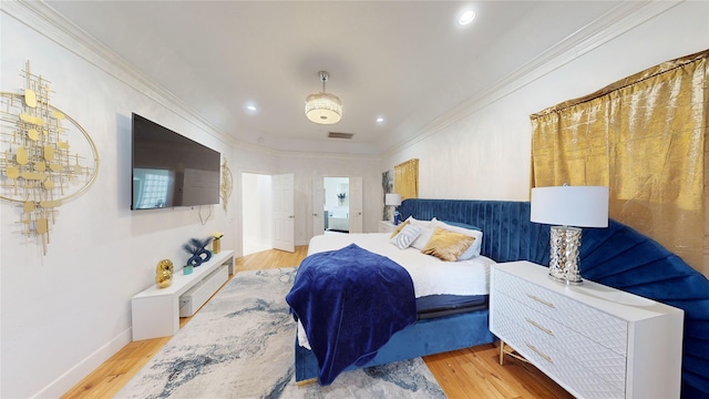 bedroom featuring hardwood / wood-style floors, ceiling fan, and crown molding