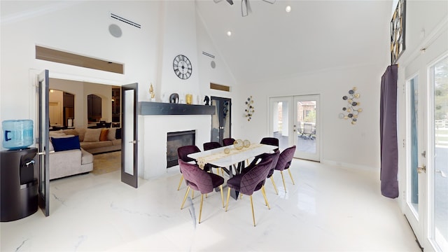 4009 Ravencrest Ct, Pearland, TX 77584 - dining space with french doors, high vaulted ceiling, a glass covered fireplace, healthy amount of natural light, and baseboards
