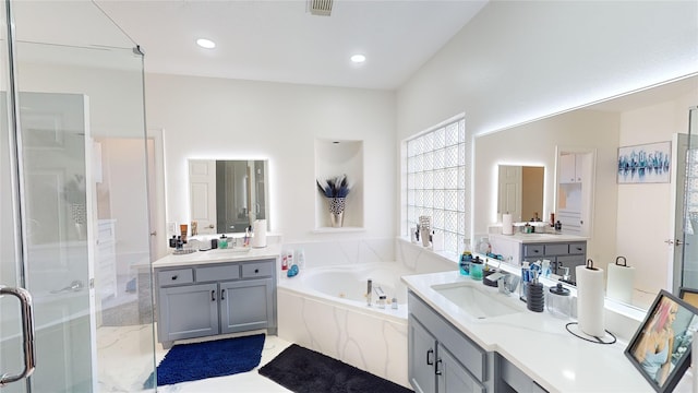 4009 Ravencrest Ct, Pearland, TX 77584 - bathroom with two vanities, a shower stall, a bath, and recessed lighting