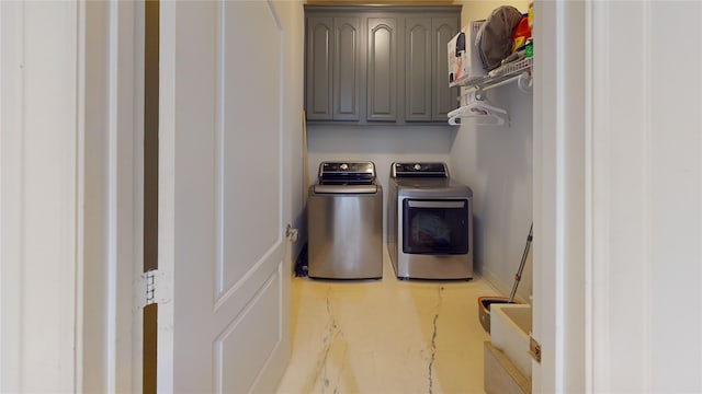 washroom featuring washer and dryer and cabinets