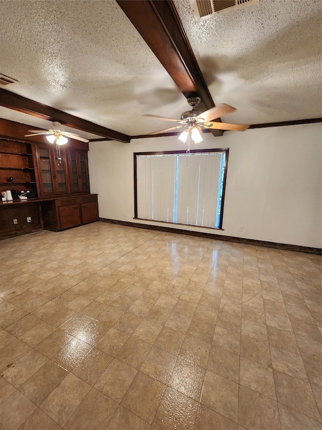 tiled empty room with a textured ceiling, ceiling fan, and beam ceiling