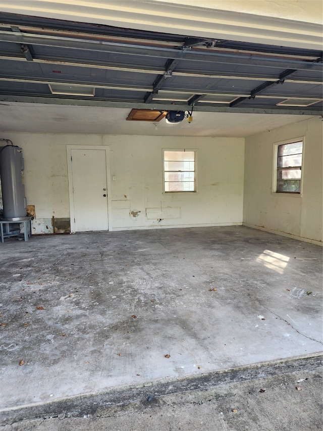 garage featuring electric water heater and a garage door opener