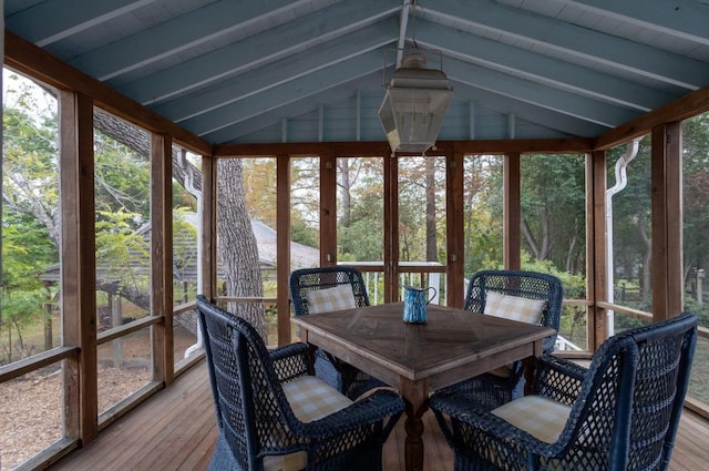 sunroom / solarium featuring plenty of natural light and lofted ceiling with beams