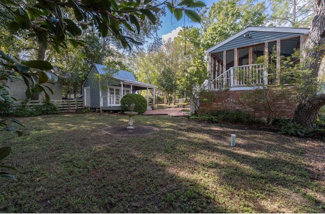 view of yard featuring fence and a sunroom