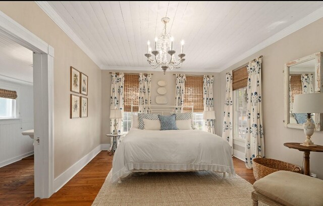 bedroom with ornamental molding, wood finished floors, baseboards, wood ceiling, and a chandelier