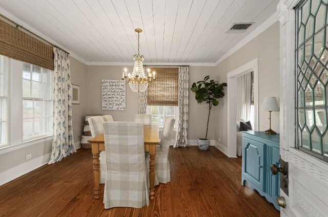 dining room with crown molding, dark wood-type flooring, and a notable chandelier