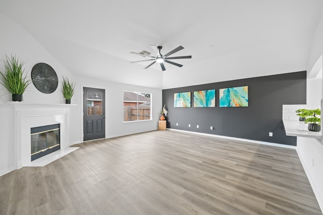 unfurnished living room featuring hardwood / wood-style flooring and ceiling fan