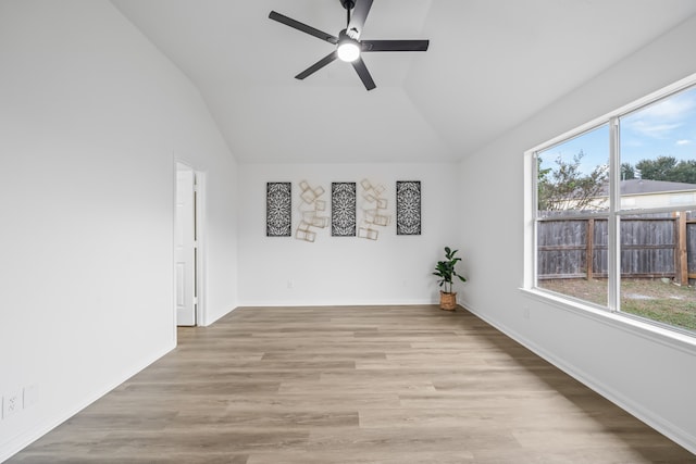 empty room featuring ceiling fan, vaulted ceiling, and light hardwood / wood-style floors