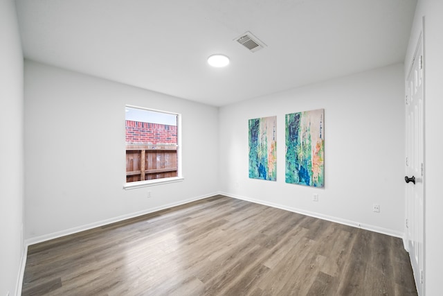 empty room featuring dark wood-type flooring