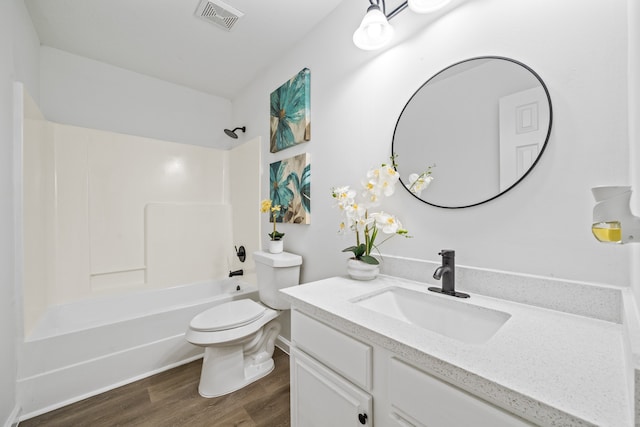 full bathroom with shower / bath combination, wood-type flooring, toilet, and vanity