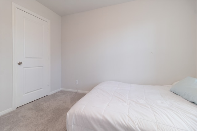 bedroom featuring light colored carpet