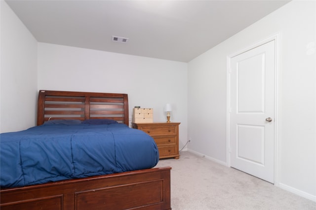 bedroom featuring light colored carpet