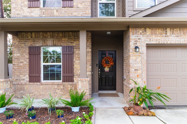 property entrance featuring a garage and covered porch