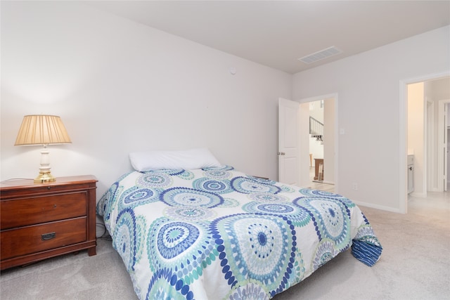 bedroom featuring light colored carpet