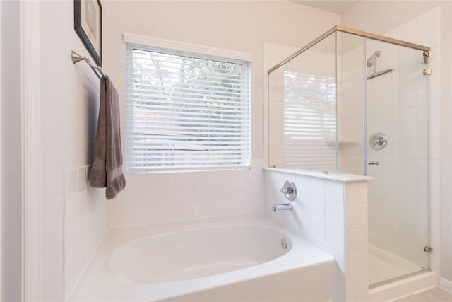 bathroom with shower with separate bathtub