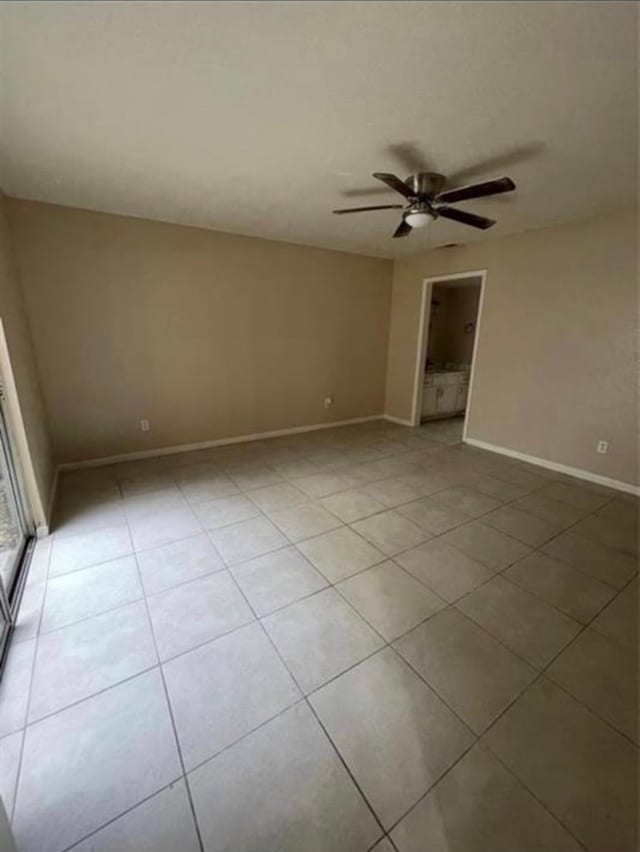 unfurnished room with light tile patterned floors and ceiling fan