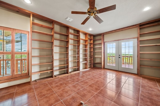 interior space with a textured ceiling, recessed lighting, a ceiling fan, visible vents, and french doors