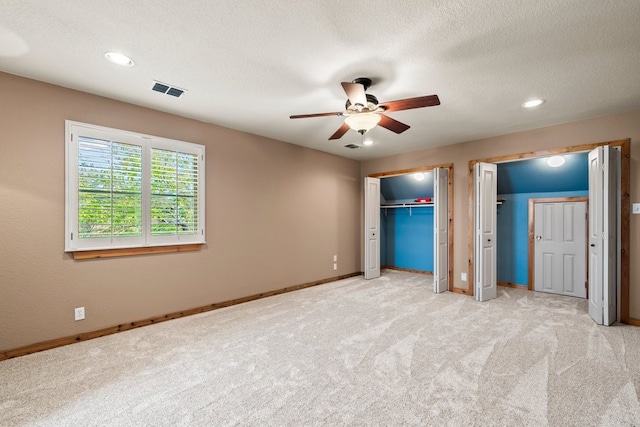 unfurnished bedroom featuring recessed lighting, a ceiling fan, light carpet, a textured ceiling, and baseboards