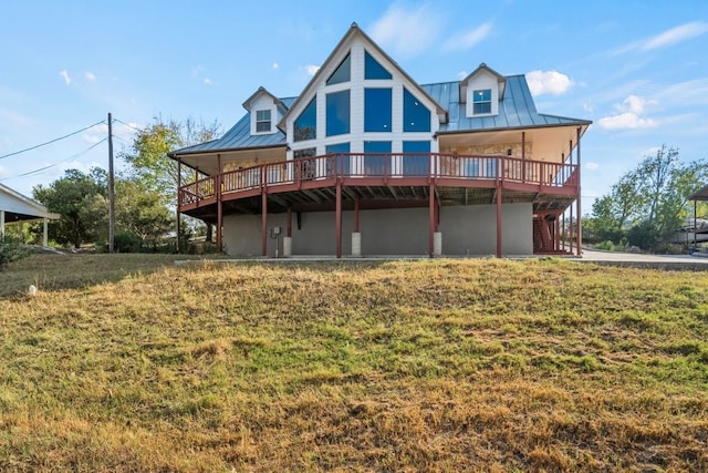 back of property featuring a standing seam roof, metal roof, and a wooden deck