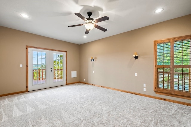 unfurnished room with french doors, light colored carpet, plenty of natural light, and baseboards