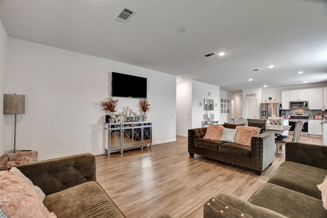 living room with light hardwood / wood-style floors