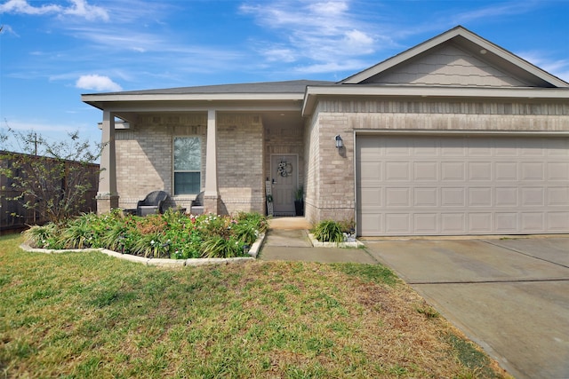 view of front of property featuring a garage and a front lawn