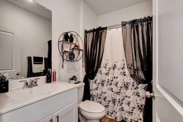 bathroom with curtained shower, wood-type flooring, vanity, and toilet