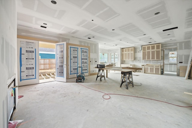 unfurnished dining area featuring concrete flooring