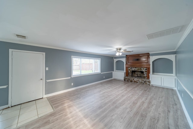 unfurnished living room featuring ceiling fan, a fireplace, light wood-type flooring, and ornamental molding