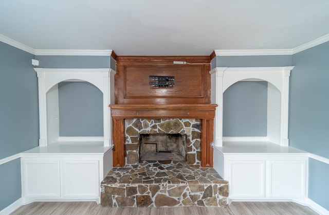 living room with a fireplace, light hardwood / wood-style floors, and ornamental molding