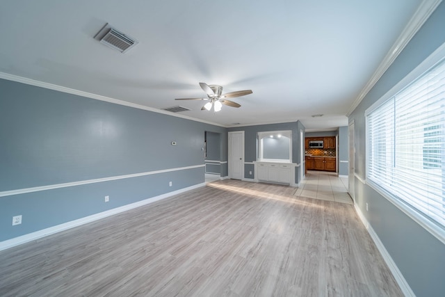 unfurnished living room featuring ceiling fan, light wood-type flooring, and ornamental molding