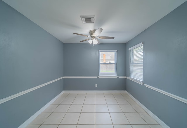 tiled empty room with ceiling fan