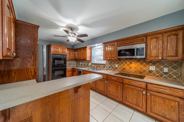 kitchen with ceiling fan, sink, decorative backsplash, light tile patterned floors, and black appliances