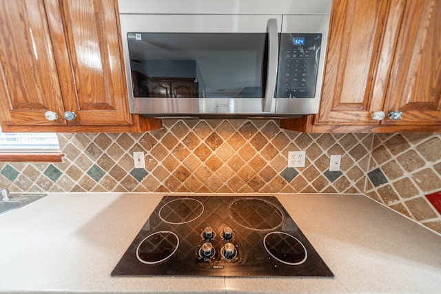 kitchen featuring black electric stovetop and decorative backsplash