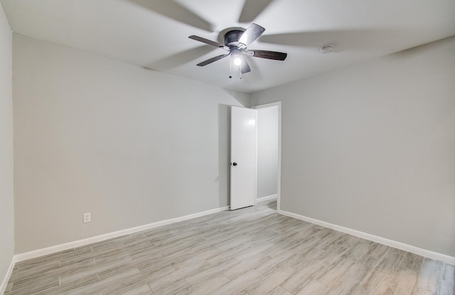 unfurnished room featuring a ceiling fan, light wood-type flooring, and baseboards