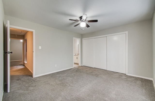 unfurnished bedroom featuring attic access, carpet, a closet, and ensuite bath