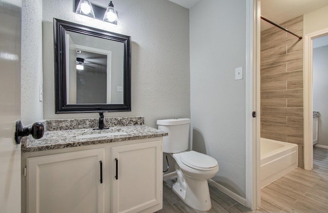 bathroom featuring bathtub / shower combination, toilet, wood tiled floor, vanity, and baseboards