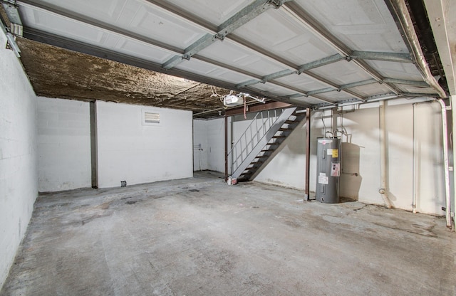 garage featuring a garage door opener and electric water heater