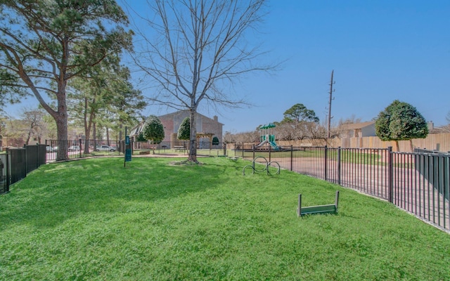 view of yard with fence and playground community