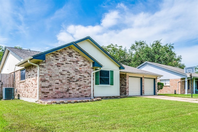 view of front facade with a front lawn, central AC unit, and a garage