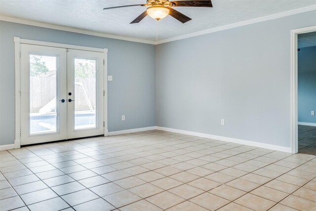 tiled empty room with crown molding, french doors, and ceiling fan