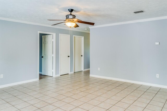 unfurnished room featuring light tile patterned floors, a textured ceiling, ceiling fan, and ornamental molding