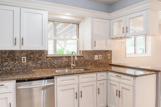 kitchen featuring dishwasher, white cabinetry, sink, and dark stone counters