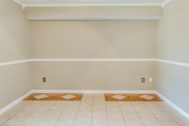 spare room with tile patterned flooring and crown molding