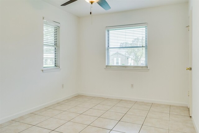 spare room featuring ceiling fan and light tile patterned floors