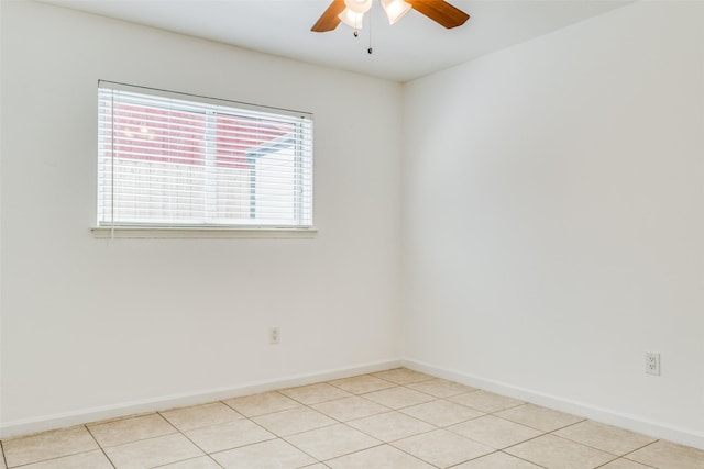 tiled spare room with ceiling fan