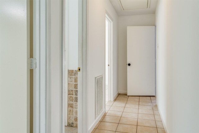 corridor featuring light tile patterned floors