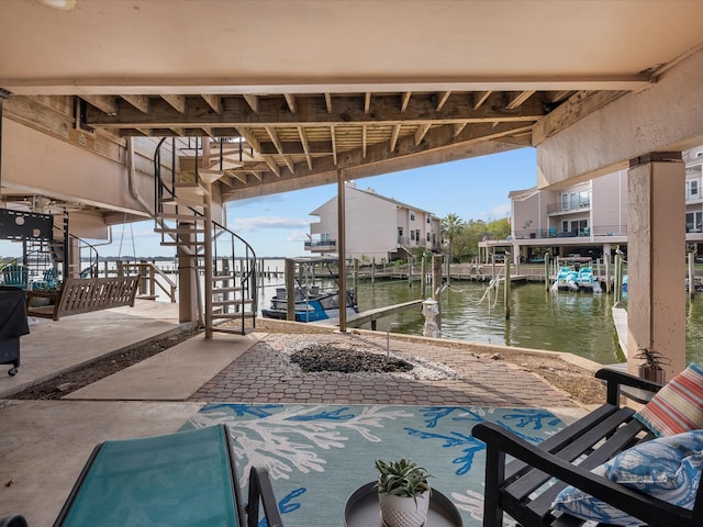 view of patio / terrace with a dock and a water view